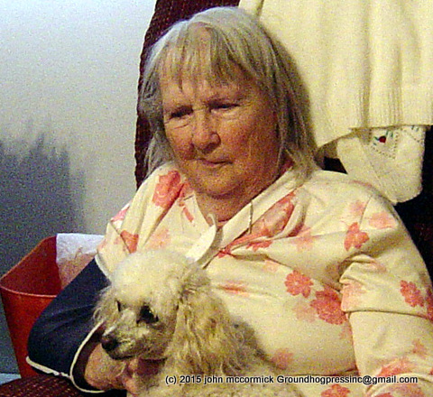 Photo of elderly woman holding lapdog.